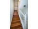Wooden staircase with white railing leading upstairs at 514 Ryans Woods Ln, Palm Harbor, FL 34683