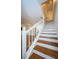 Elegant wooden staircase with white railings leading to the upper level at 514 Ryans Woods Ln, Palm Harbor, FL 34683