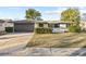 Ranch-style home with a brown garage door and well-manicured lawn at 7027 Fireside Dr, Port Richey, FL 34668