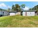 Backyard with two sheds and grassy area at 7424 Lance St, Zephyrhills, FL 33541