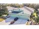 Aerial view of a light green house with double garage and holiday decor at 7546 Deer Path Ln, Land O Lakes, FL 34637