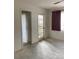 Empty bedroom with new flooring, ceiling fan, and sliding door to balcony at 8198 Terrace Garden N Dr # 407, St Petersburg, FL 33709
