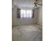 Empty bedroom with new flooring, ceiling fan and window coverings at 8198 Terrace Garden N Dr # 407, St Petersburg, FL 33709