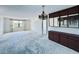 Open living room with dark wood built in cabinet, window, and entrance to another room at 8198 Terrace Garden N Dr # 407, St Petersburg, FL 33709