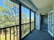 Relax on this screened-in patio with a view of mature trees at 8198 Terrace Garden N Dr # 407, St Petersburg, FL 33709