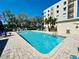 Community pool with plenty of lounge chairs and shade at 8198 Terrace Garden N Dr # 407, St Petersburg, FL 33709