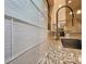 Close-up of kitchen backsplash and modern gold faucet at 8680 Quinn Ct, North Port, FL 34287