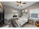 Cozy bedroom featuring stylish decor, a ceiling fan, and natural light at 8707 Beverly Dr, Temple Terrace, FL 33617