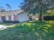 House exterior with a walkway and American flag at 9022 Ramsgate Dr # 9022, New Port Richey, FL 34655