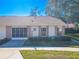 Brick front exterior of charming villa with American flag at 9022 Ramsgate Dr # 9022, New Port Richey, FL 34655