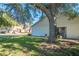 House exterior showcasing a large tree and well-maintained lawn at 9022 Ramsgate Dr # 9022, New Port Richey, FL 34655