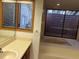 Well-lit bathroom features a vanity and soaking tub with a large window at 10 Woodridge Cir, Oldsmar, FL 34677