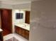 Bathroom featuring a sink with brown cabinets and a walk-in closet at 10 Woodridge Cir, Oldsmar, FL 34677