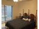 Cozy bedroom featuring a comfortable bed and pleasant natural light from the window at 10 Woodridge Cir, Oldsmar, FL 34677