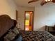 Bedroom with king bed, ceiling fan and access to the hallway at 10 Woodridge Cir, Oldsmar, FL 34677