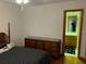 Bedroom with dresser and access to bathroom at 10 Woodridge Cir, Oldsmar, FL 34677