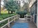 Deck with railings overlooking greenery and a peek of the distant golf course at 10 Woodridge Cir, Oldsmar, FL 34677