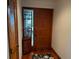 Inviting entryway featuring a wooden front door and tiled floor at 10 Woodridge Cir, Oldsmar, FL 34677