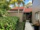 Condo exterior showcasing walkway, landscaping, and building details at 10 Woodridge Cir, Oldsmar, FL 34677