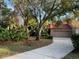 Condo exterior with driveway, garage, and landscaping at 10 Woodridge Cir, Oldsmar, FL 34677