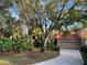 Condo exterior showcasing driveway, garage, and mature trees at 10 Woodridge Cir, Oldsmar, FL 34677