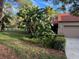 Condo exterior with lush landscaping and a garage at 10 Woodridge Cir, Oldsmar, FL 34677