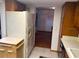 Eat-in kitchen with refrigerator, cabinets, and wood flooring at 10 Woodridge Cir, Oldsmar, FL 34677