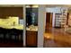 Wet bar with small sink next to the open kitchen, ideal for entertaining at 10 Woodridge Cir, Oldsmar, FL 34677