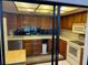 Well-lit kitchen with wood cabinets, modern appliances, and neutral countertops at 10 Woodridge Cir, Oldsmar, FL 34677