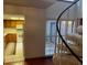 Living room with kitchen and spiral staircase access at 10 Woodridge Cir, Oldsmar, FL 34677