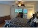 Cozy main bedroom with a decorative ceiling fan and a private balcony entrance at 10 Woodridge Cir, Oldsmar, FL 34677