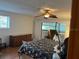 Comfortable bedroom featuring a ceiling fan and a view to the balcony at 10 Woodridge Cir, Oldsmar, FL 34677