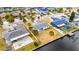 Aerial view showing a house on the waterfront with a pool and neighboring houses at 1009 Spindle Palm Way, Apollo Beach, FL 33572