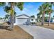 Modern home exterior featuring a clean, white finish and attached garage at 1009 Spindle Palm Way, Apollo Beach, FL 33572