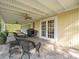 Covered back patio with wicker furniture, ceiling fans, and access to the backyard at 10114 Lindelaan Dr, Tampa, FL 33618