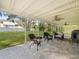 Spacious covered patio with wicker furniture overlooking a grassy backyard at 10114 Lindelaan Dr, Tampa, FL 33618