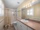 Bathroom features a shower/tub combo, vanity with a large mirror, and natural light at 10114 Lindelaan Dr, Tampa, FL 33618