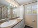 Bright bathroom with double vanity, tiled walls, and plantation shutters at 10114 Lindelaan Dr, Tampa, FL 33618