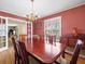 Dining room with wood floors, chandelier, and view to adjacent living area at 10114 Lindelaan Dr, Tampa, FL 33618