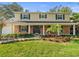 Inviting two-story home with brick facade, covered porch, and landscaped yard at 10114 Lindelaan Dr, Tampa, FL 33618