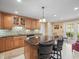 Kitchen features a granite island with seating, stainless steel appliances, wood cabinets, and an eat-in area at 10114 Lindelaan Dr, Tampa, FL 33618