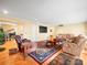 Inviting living room with comfortable seating, hardwood floors, and a view of the piano room at 10114 Lindelaan Dr, Tampa, FL 33618