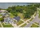 Beautiful aerial view of the home showcasing the lush landscaping and proximity to the water at 102 Shore E Dr, Oldsmar, FL 34677
