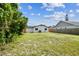 View of the private backyard, enclosed by a wooden fence, ideal for relaxation or play at 102 Shore E Dr, Oldsmar, FL 34677