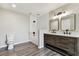 This bathroom features dual sinks and wood look flooring at 102 Shore E Dr, Oldsmar, FL 34677