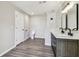 Bathroom with dual sinks, a separate water closet, and wood look floors at 102 Shore E Dr, Oldsmar, FL 34677