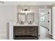 Bathroom with dual sinks, tile backsplash and wood look flooring at 102 Shore E Dr, Oldsmar, FL 34677