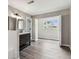 Bathroom featuring wood look floors, dual sinks and tile backsplash at 102 Shore E Dr, Oldsmar, FL 34677