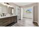 Bathroom featuring wood look floors, dual sinks and tile backsplash at 102 Shore E Dr, Oldsmar, FL 34677
