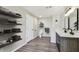 Modern bathroom features floating shelves, white tiled shower, and dual sink vanity at 102 Shore E Dr, Oldsmar, FL 34677